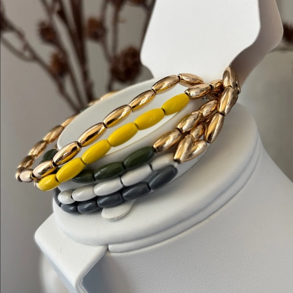 Laura Ford Goldtone 5 Row Rice bead yellow,green, blues & white,chunky stretch